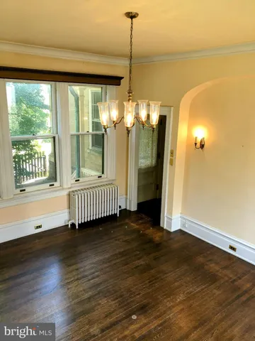 a view of hall way with furniture and chandelier