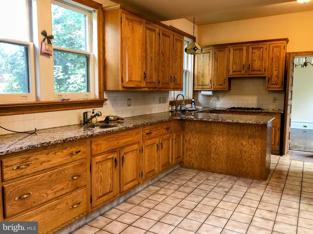 a view of an entryway with wooden floor and door