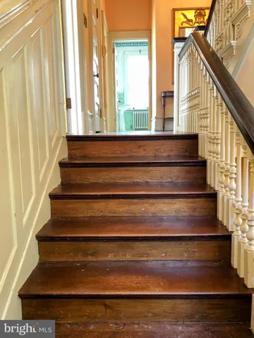a view of empty room with wooden floor and cabinet