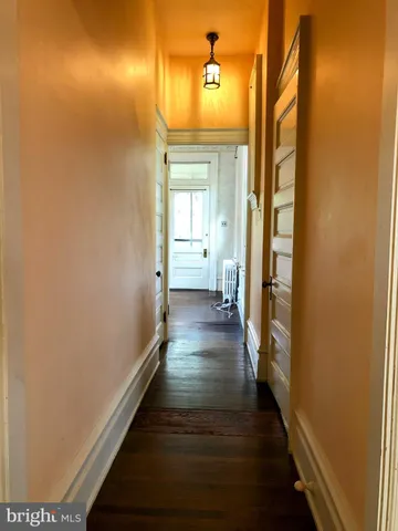 a view of an empty room and wooden floor