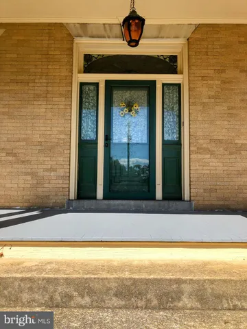 an empty room with floor to ceiling window and fireplace