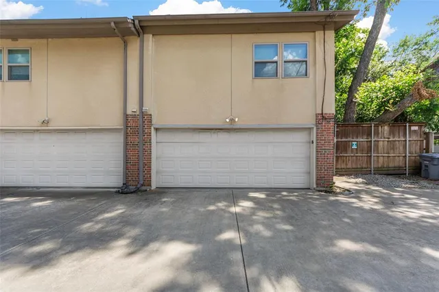 a view of small house with garage