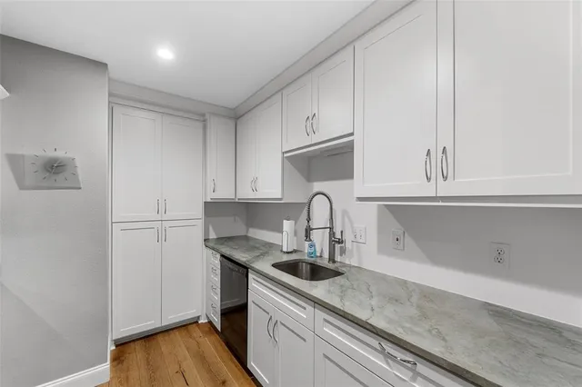 a kitchen with white cabinets and a sink