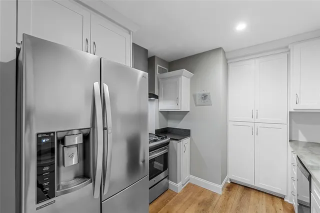 a kitchen with stainless steel appliances a refrigerator and a stove top oven