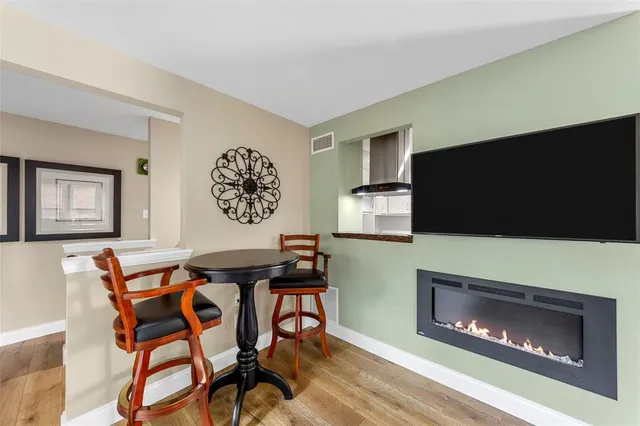 a dinning room with furniture and a fireplace