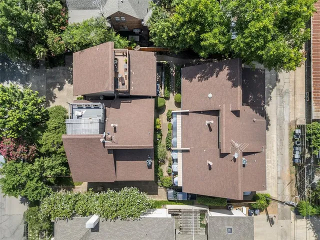 an aerial view of residential house with outdoor space and trees all around