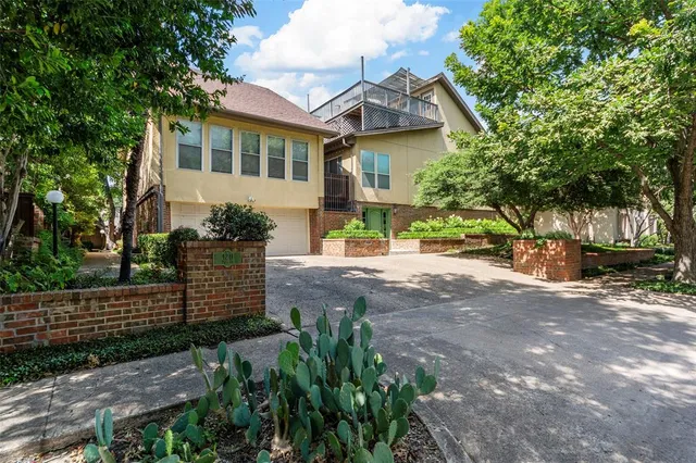 a view of a house with a yard and tree s