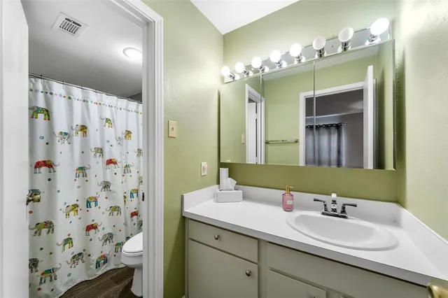 a bathroom with a double vanity sink mirror and shower