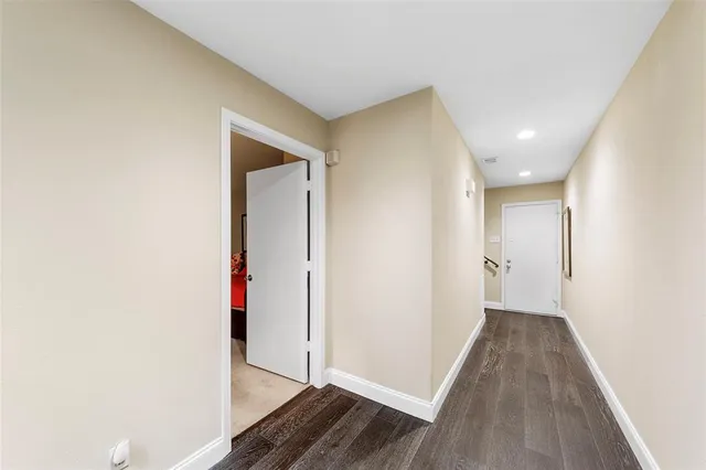a view of hallway with wooden floor