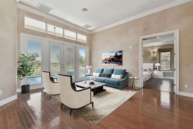 a kitchen with stainless steel appliances granite countertop a stove top oven a sink dishwasher and wooden cabinets with wooden floor