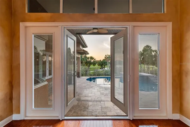 a kitchen with stainless steel appliances granite countertop a sink dishwasher stove and refrigerator with wooden floor