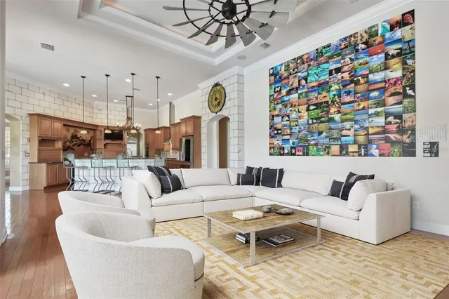 a bedroom with a large bed and wooden floor