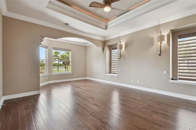 an empty room with chandelier fan