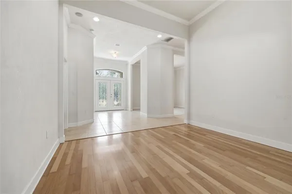 an empty room with a bathroom and a mirror
