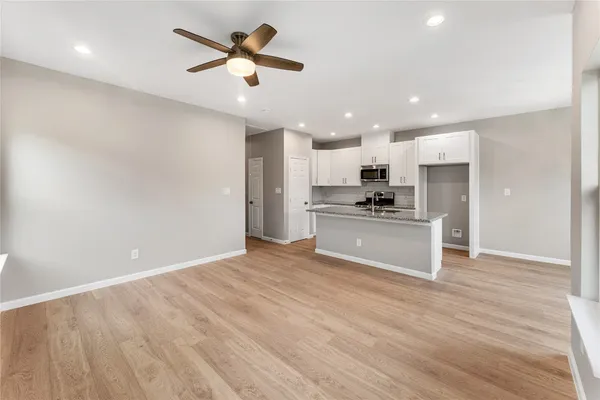 a view of kitchen with refrigerator and microwave