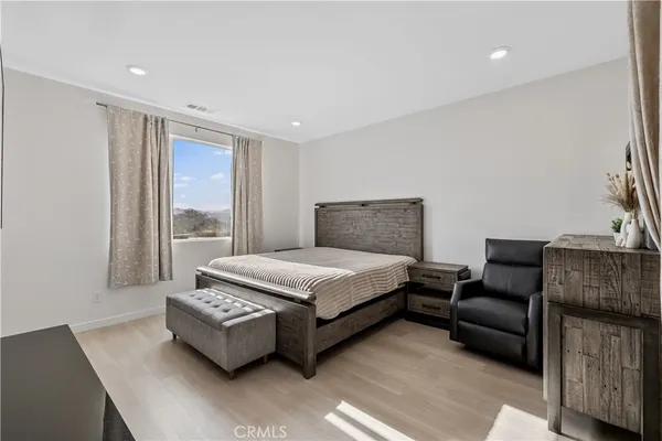 a bedroom with furniture and a window