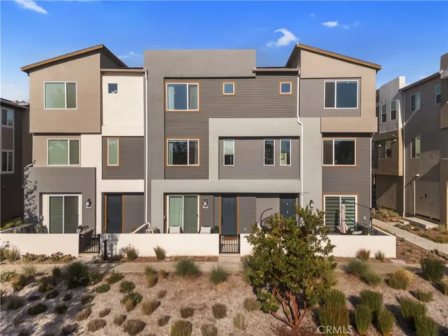 a front view of a residential apartment building with a yard