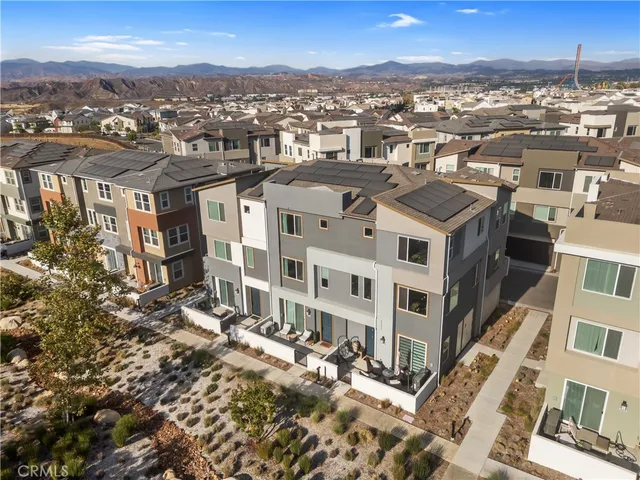 an aerial view of a residential houses with city view
