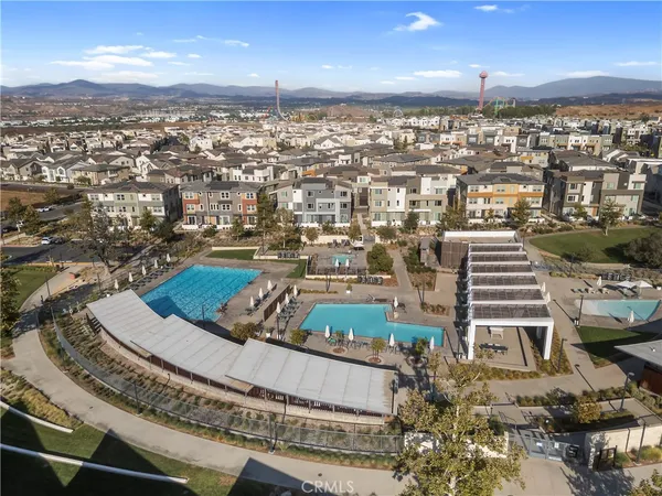 an aerial view of residential building with outdoor space and ocean view