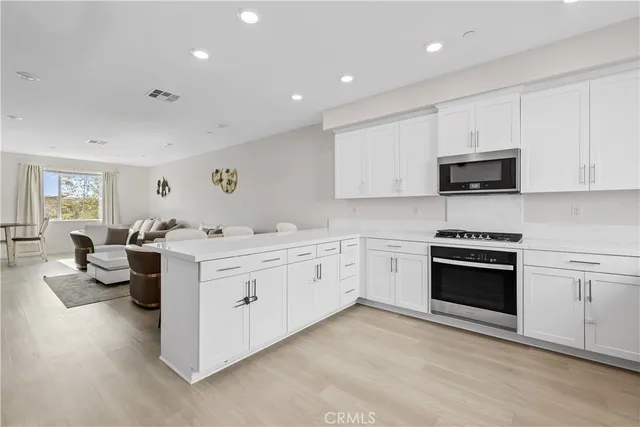a kitchen with sink stove and cabinets