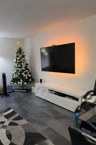 a living room with couch and a flat screen tv