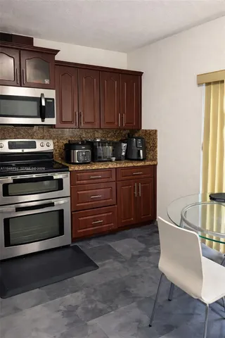 a kitchen with stainless steel appliances granite countertop a stove and a sink