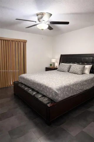 a large bed sitting in a bedroom next to a lamp