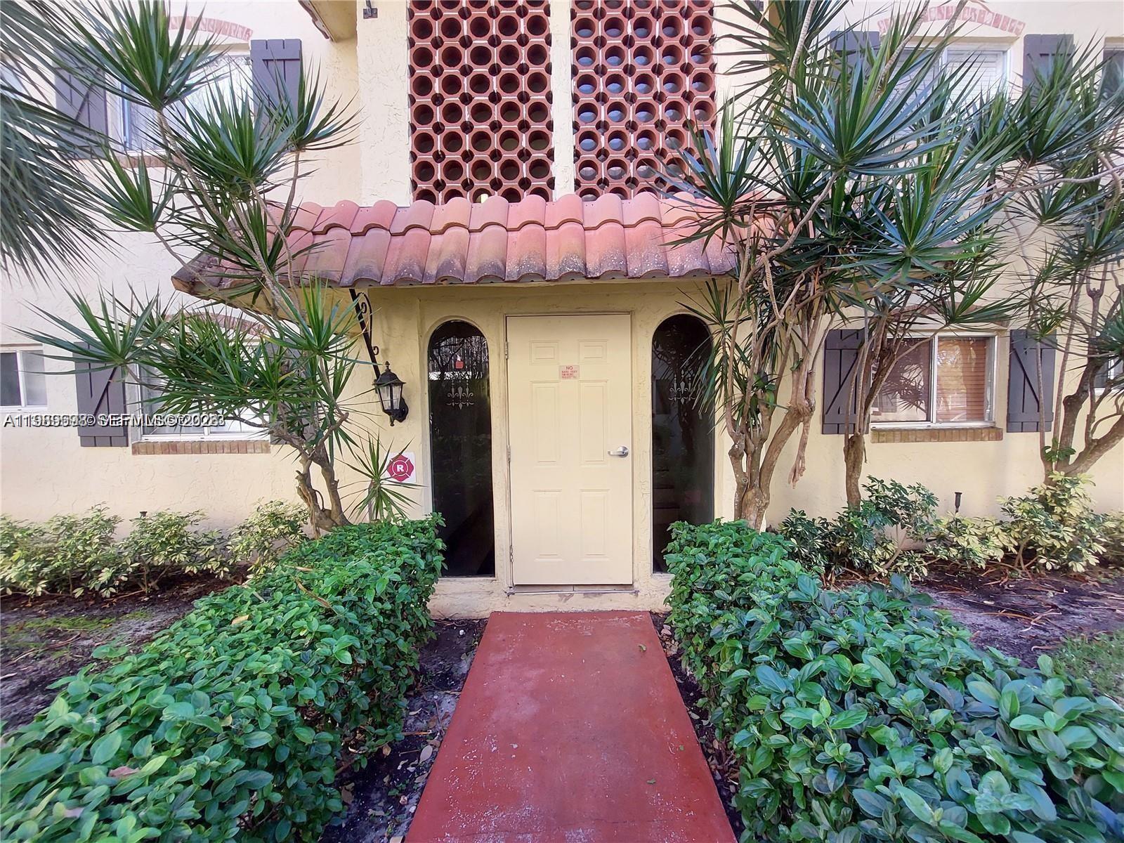 253 South Cypress Road, Unit 214 Pompano Beach, FL 33060 - Photo 19 of 25 a front view of a house with a yard