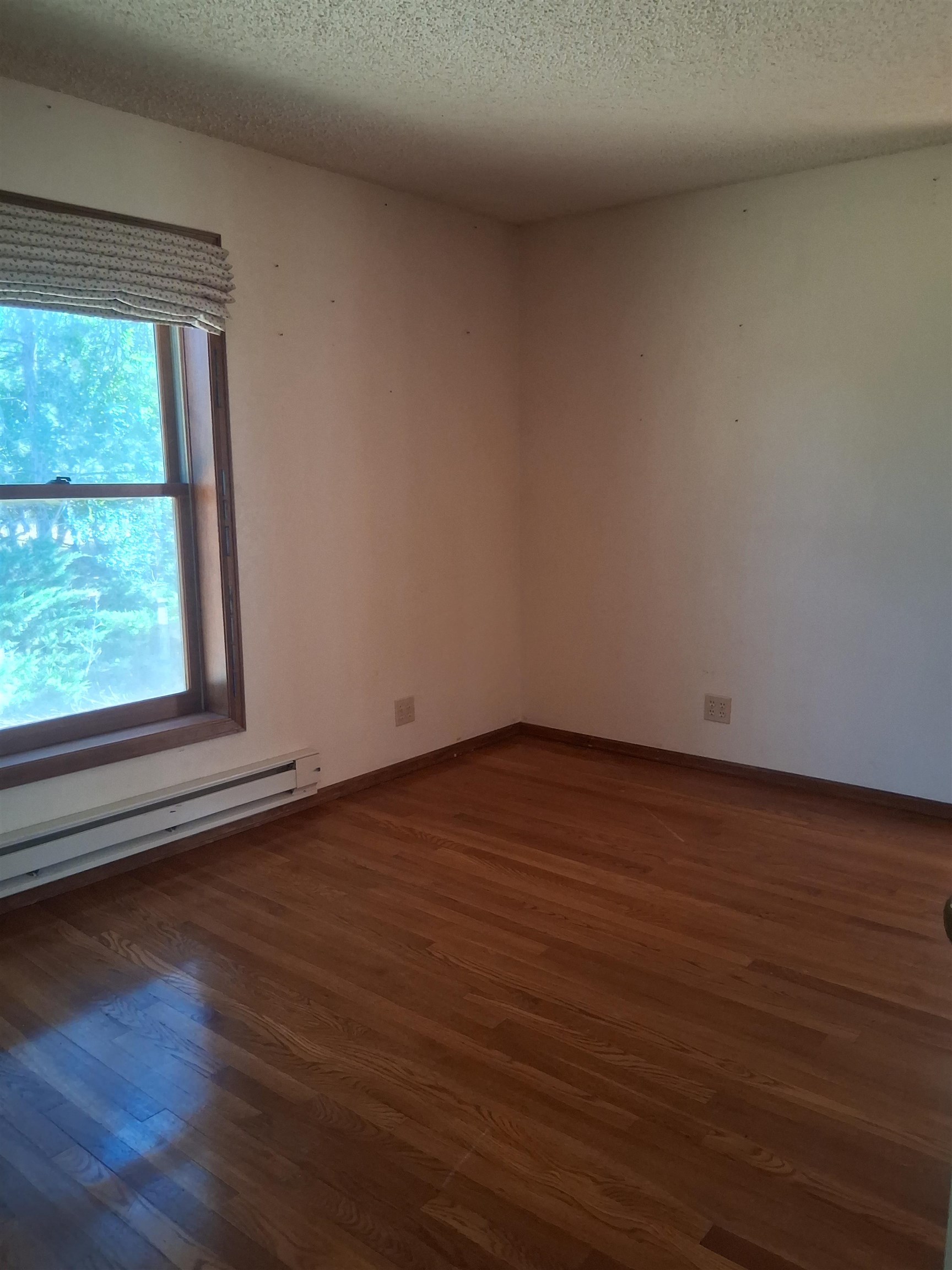 1983 River Road Fruita, CO 81521 - Photo 23 of 31 a view of an empty room with wooden floor and a window
