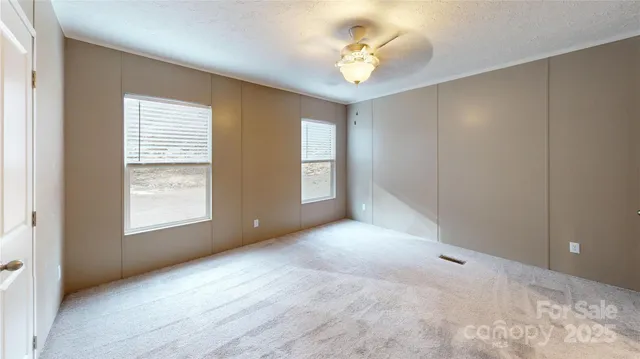 a view of an empty room with windows