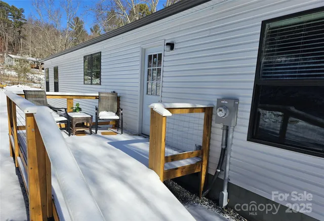 a view of a patio with table and chairs with wooden floor and fence