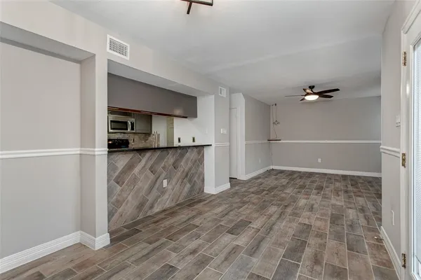 a view of a kitchen with a sink and a refrigerator