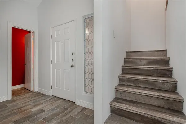 a view of an entryway with wooden floor