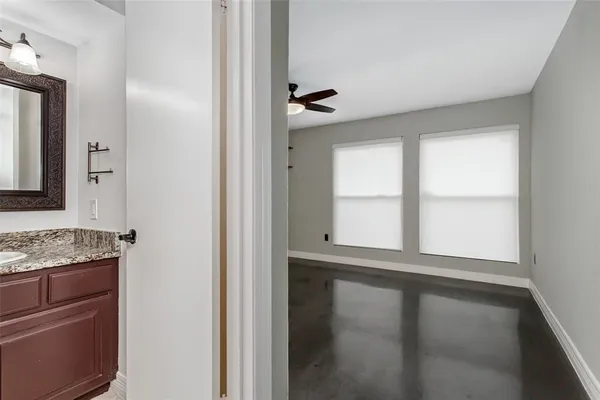 a bathroom with a granite countertop sink a mirror and a window