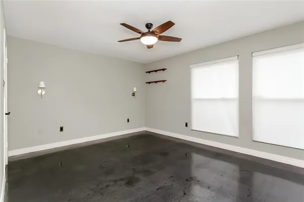 an empty room with closet and windows