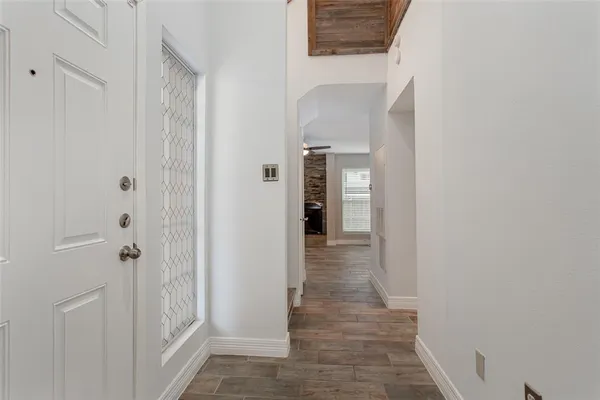 a view of a hallway with wooden floor and closet