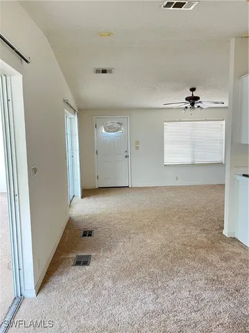 an empty room with a empty space and windows