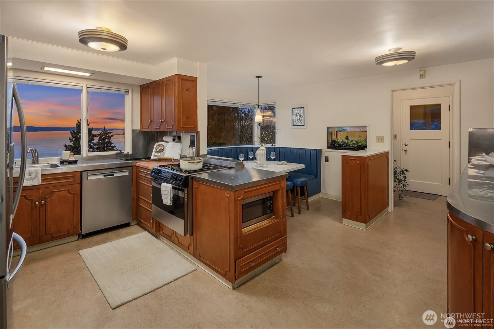 727 Southwest 199th Place Normandy Park, WA 98166 - Photo 12 of 38 a kitchen with a sink stove and cabinets