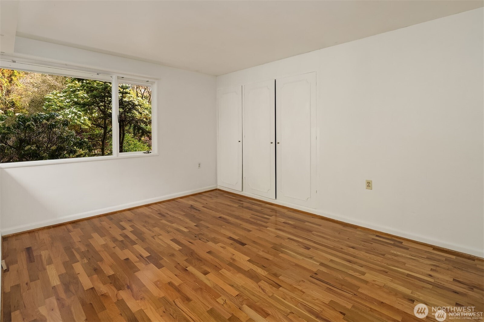 727 Southwest 199th Place Normandy Park, WA 98166 - Photo 22 of 38 a view of an empty room with wooden floor and a window