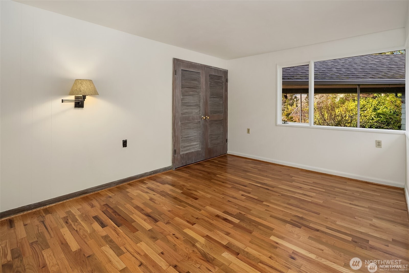 727 Southwest 199th Place Normandy Park, WA 98166 - Photo 24 of 38 a view of empty room with wooden floor and fan