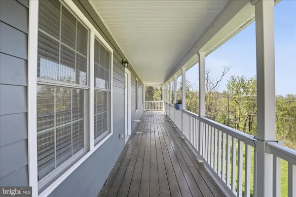 a view of a balcony with wooden floor