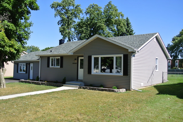 a house that has a large tree in front of it