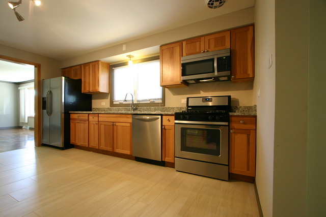 10549 Oak Park Avenue Chicago Ridge, IL 60415 - Photo 11 of 25 a kitchen with a sink stainless steel appliances and cabinets