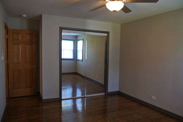 10549 Oak Park Avenue Chicago Ridge, IL 60415 - Photo 19 of 25 a view of an empty room with wooden floor and a window
