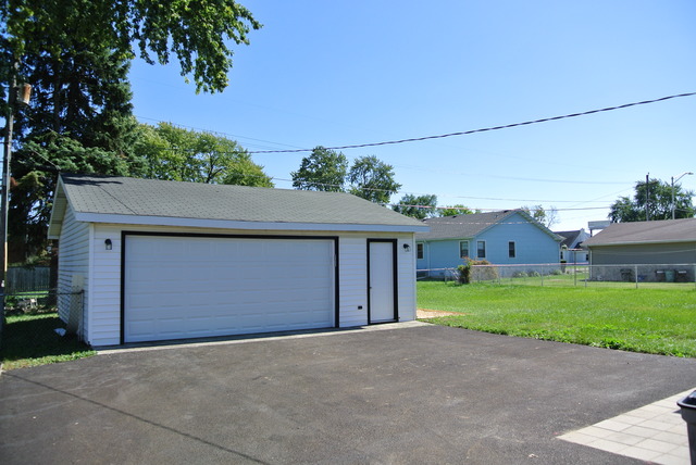 10549 Oak Park Avenue Chicago Ridge, IL 60415 - Photo 5 of 25 a front view of a house with a yard and garage