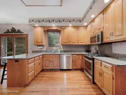 a kitchen with stainless steel appliances granite countertop a stove and a sink