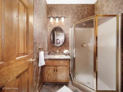 a bathroom with a mirror and a shower