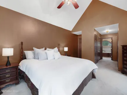 a bedroom with a bed and a lamp