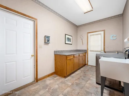 a view of a hallway with a sink and a mirror