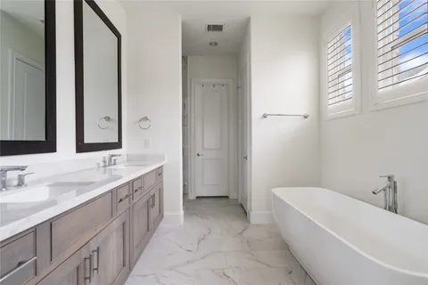 a bathroom with a double vanity sink mirror and double